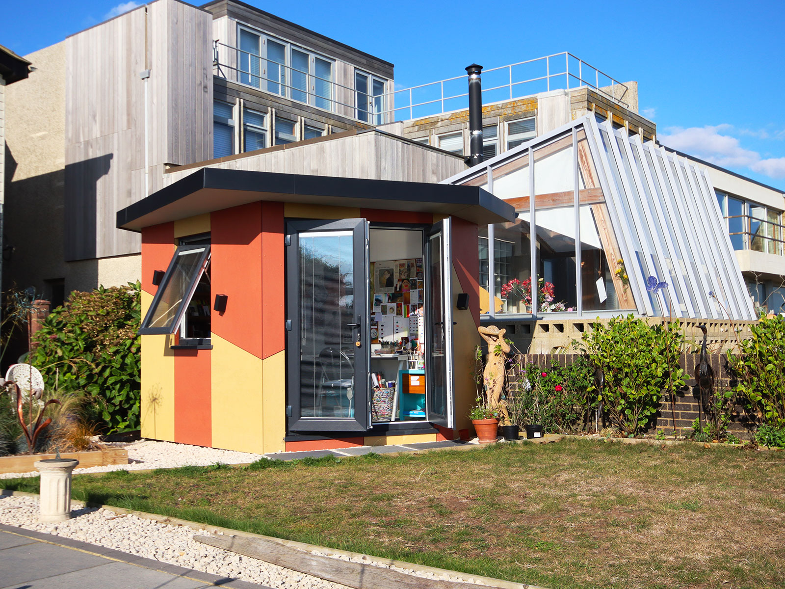 Bespoke designer garden art studio with colourful cladding