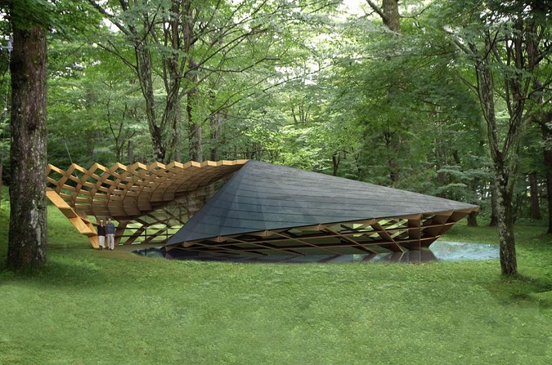 A modern architectural structure with a geometric, angular design covered in wooden and slate materials is situated in a forested area, blending with the surrounding trees and greenery. Two people are standing near the structure's entrance, marveling at the impressive architecture. - a room in the garden