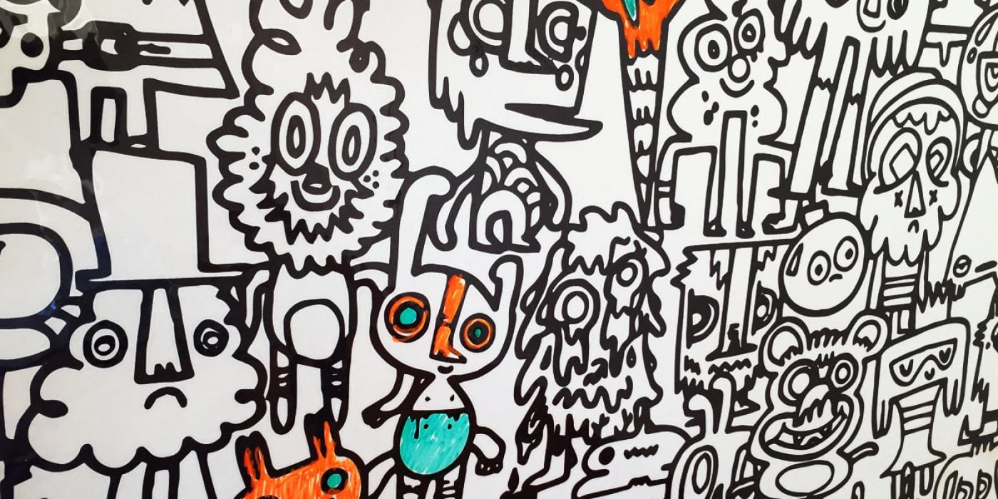 A mural filled with various quirky and whimsical doodles in black and white, featuring cartoonish faces and abstract figures, perfect for garden baby room ideas. Some characters have colorful accents such as orange and turquoise. The designs are densely packed, creating a vibrant and playful scene. - a room in the garden