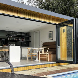 Unique designer pool house with bi-folding doors
