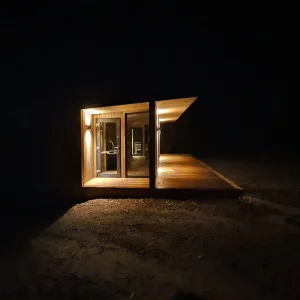 Large unique garden office with roof overhang and decking