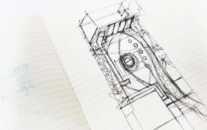 A sketch of a building or architectural structure drawn in black ink on an open lined notebook. The design features curved and angular elements, with circles and lines indicating various details and sections, including thoughtfully integrated garden rooms. - a room in the garden