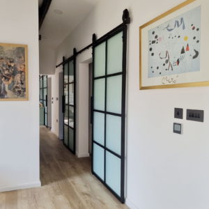 Interior hallway with sliding doors for unique mobile home