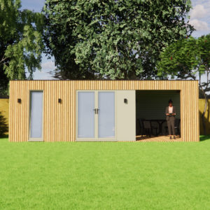 A modern, wooden cabin with tall glass doors and a seating area on the right. The cabin has vertical wooden slats on its exterior. A person is standing in the seating area, partially shaded by the cabin roof, in a grassy yard with trees in the background. - a room in the garden