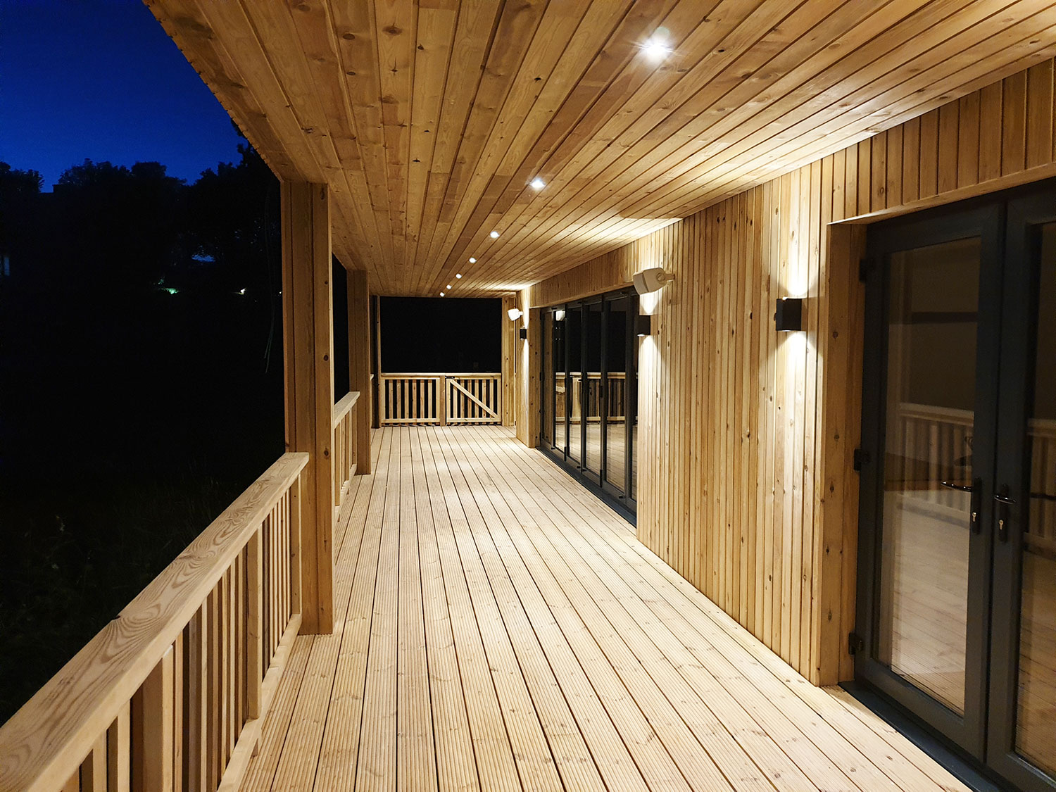 Wooden decking and roof overhang for designer garden room office cabin