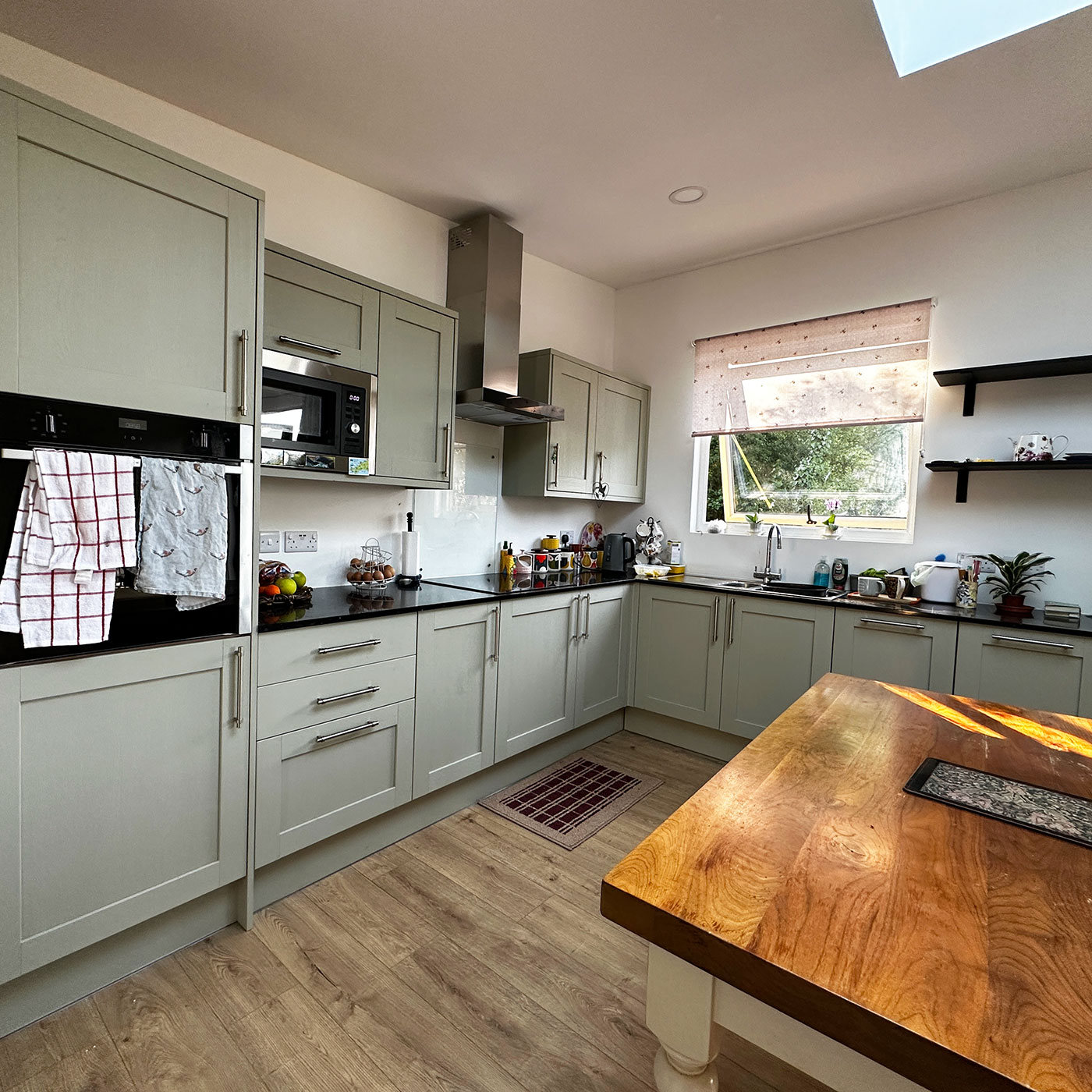 Designer kitchen with sage green cabinets