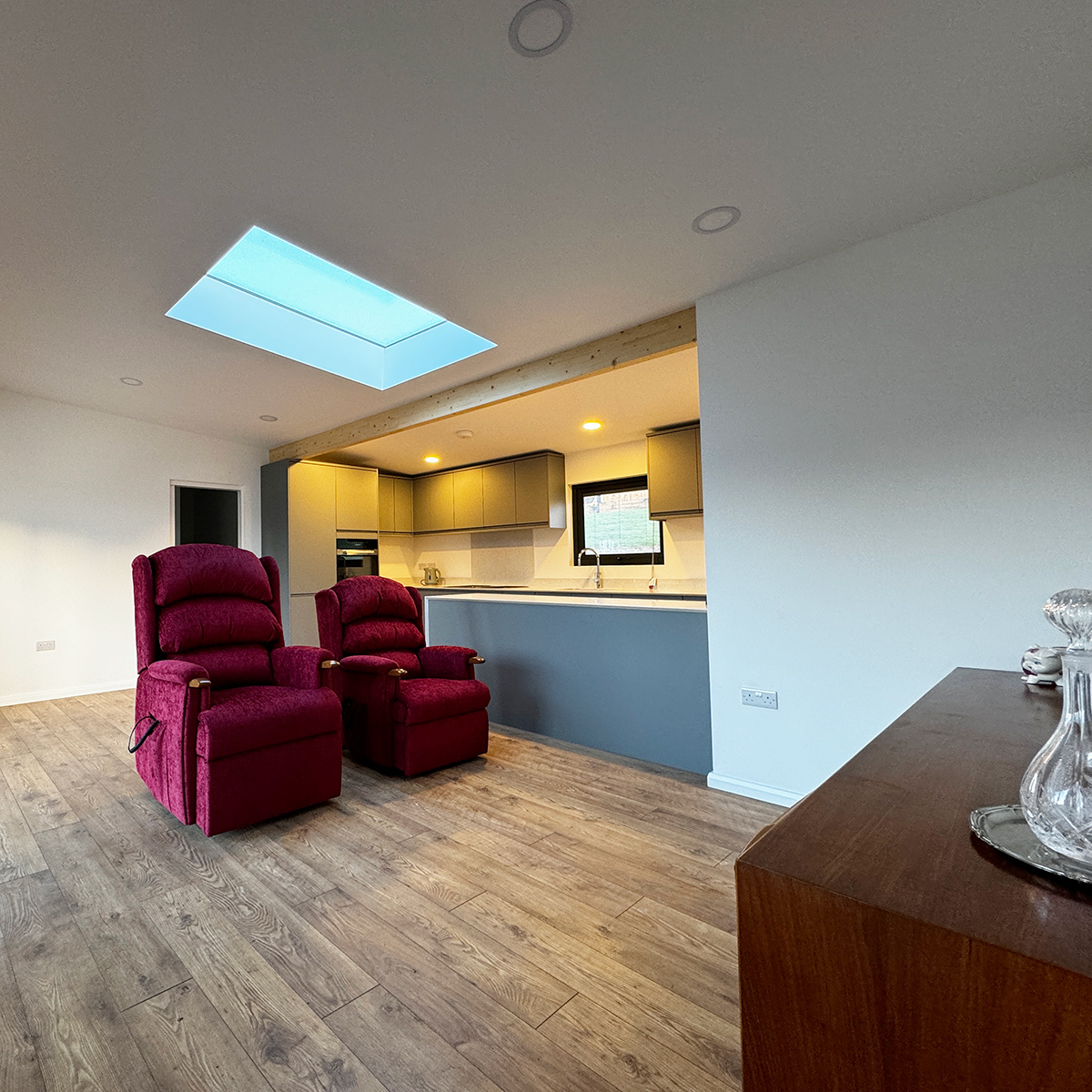 Open-plan lounge and kitchen with skylight