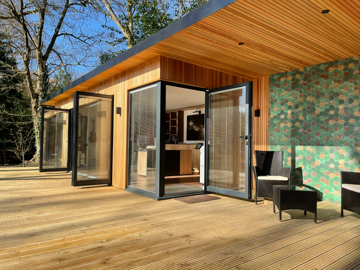 Bespoke garden office with large decked area and outdoor wallpaper