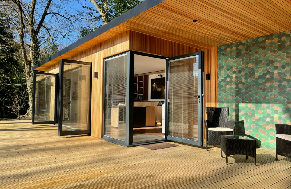 Bespoke garden office with a large decked area and outdoor wallpaper